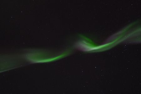 A multihued aurora ripples across the night sky over Tromsø, Norway, on January 19. Auroras happen when high-energy particles from the sun slam into Earth's atmosphere, exciting gas molecules in the air and causing them to emit light. The colors seen depend on the type of molecules involved and the altitude at which the most interactions are happening. Green is the most common shade for auroras and is produced by oxygen molecules at relatively low altitudes—between 62 and 186 miles.