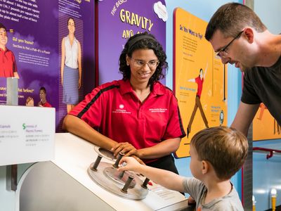 In the National Air and Space Museum’s How Things Fly gallery last September, Explainer Rae Stewart helps a young visitor understand the forces acting on an aircraft in flight.