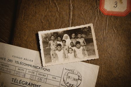 Monique Bitu Bingi was taken from her family as a girl and placed with nuns at the Katende mission (she&#39;s pictured on the lower left in the photograph). The telegram announces the arrival of more children at the mission.