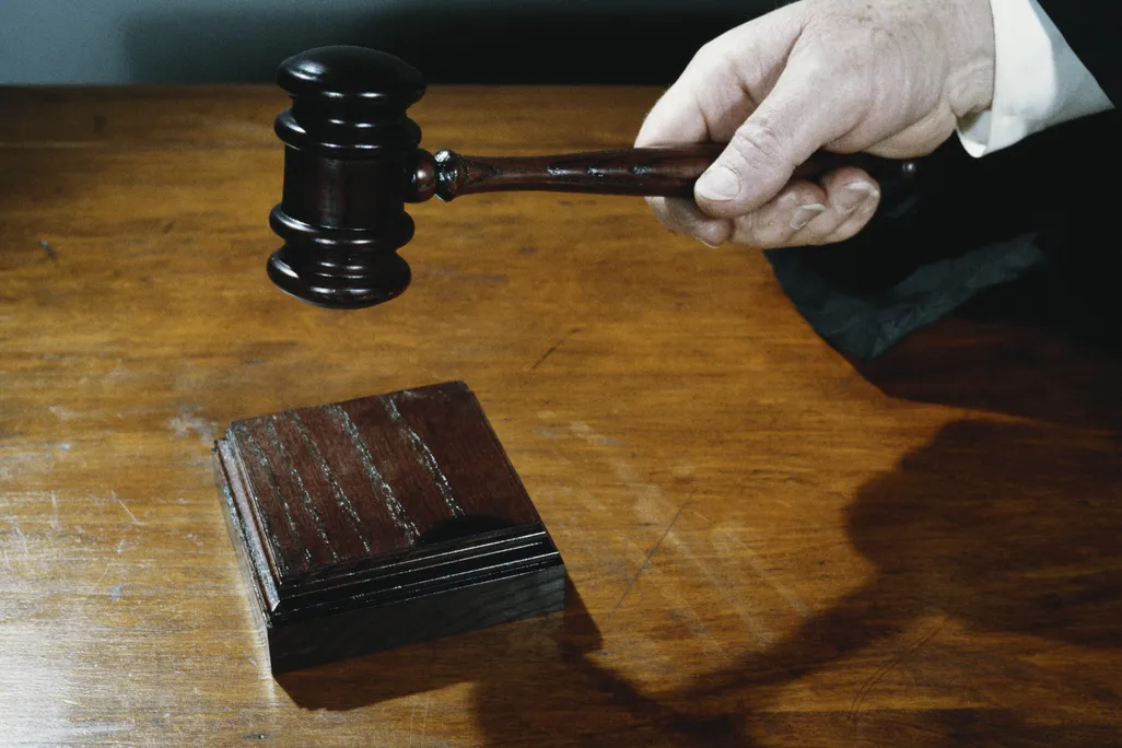 a hand holds a gavel