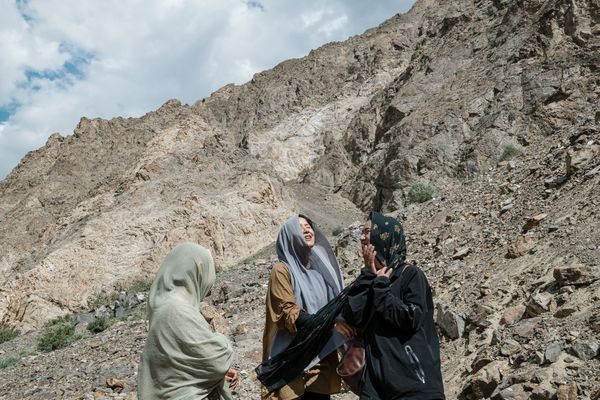 Three Muslim girls laugh while climbing mountains in Kargil, Ladakh. thumbnail