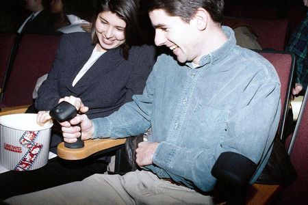 Moviegoers familiarize themselves with the joystick that will allow them to interact with the film I’m Your Man during its premiere on Dec. 16, 1992.