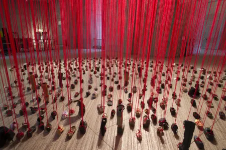 Japanese artist Chiharu Shiota tied red yarn to hundreds of unpaired shoes for "Perspectives," opening August 30 at the Arthur M. Sackler Gallery.