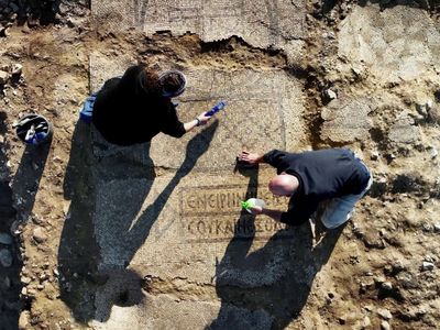 Maayan Margulis and Shira Lifshitz clean the mosaic.