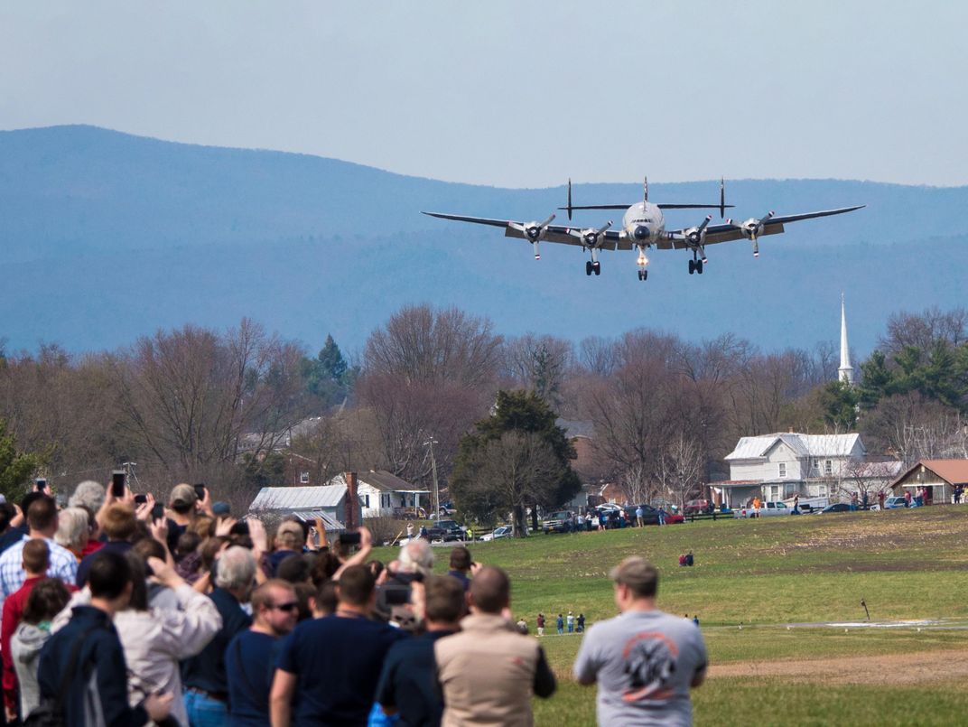 Columbine II making a final approach to Dynamic Aviation's airpark as people take photos