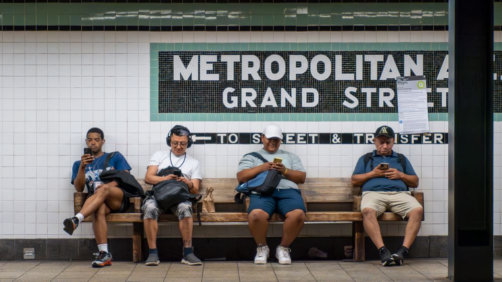 While waiting on the opposite subway platform, I snapped a photo of the men, all on their cell phones, sitting across from me. I could not help but think this represents the American experience for so many people in the U.S. today.