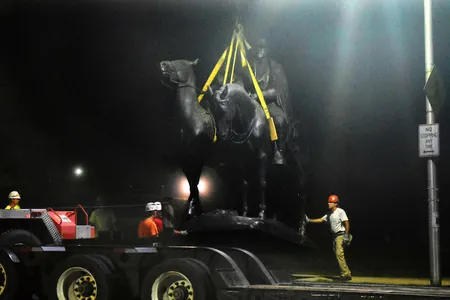 Workers remove the Robert E. Lee and Thomas J. "Stonewall" Jackson monument in Wyman Park early Wednesday, Aug. 16, 2017.