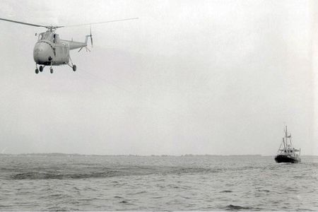 A Sikorsky HO4S Tugbird drags a ship around the ocean off Florida. 