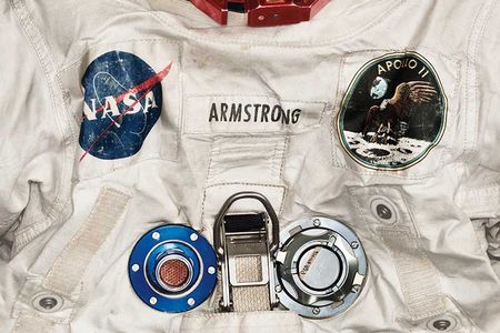 Armstrong’s pressurized spacesuit, measuring nearly 5 feet 7 inches tall, featured anodized aluminum gauges and valves. (Detail)