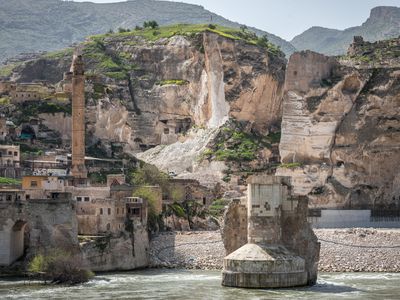 The ancient Silk Road trading post of Hasankeyf, which sits on the banks of Tigris River in southeast Turkey, will soon be flooded by the Ilisu Dam. Picture here, Construction crews destroy limestone cliffs around Hasankeyf that are dotted with neolithic caves in preparation for submerging later this summer