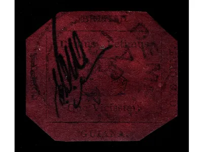 The 1856 British Guiana One-Cent Magenta, with its three-masted sailing ship, carries the postal clerk Edmond D. Wight's initials to deter counterfeiters.
