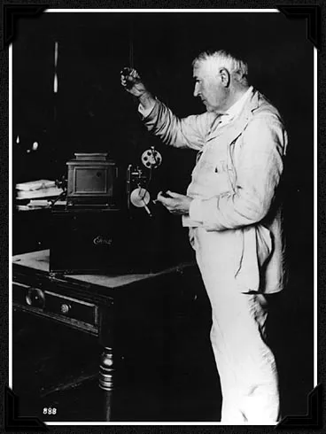 Edison examines one of his kinetoscopes in 1912