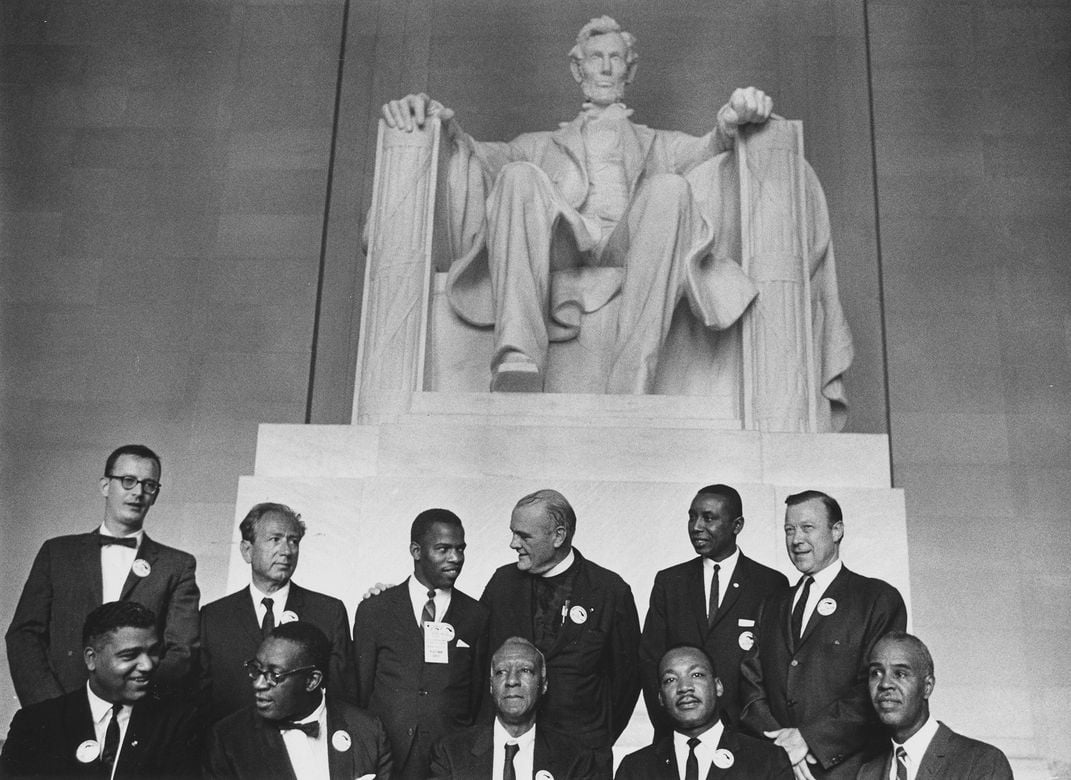 Leaders of the March on Washington pose in front of a statue of Abraham Lincoln