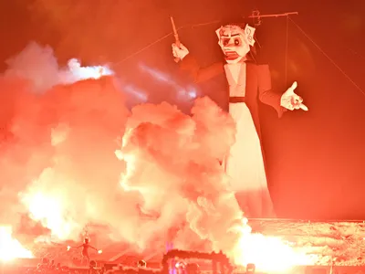 A fire dancer lights a fire beneath Zozobra during the 99th Annual Burning of Zozobra at Fort Marcy Park on September 1, 2023 in Santa Fe, New Mexico. 