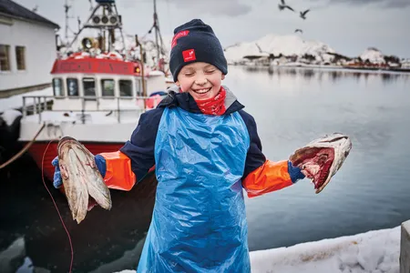 J&oslash;rgen Botolfsen, pictured in 2020 outside Ballstad Fisk AS, where he helps process cod. &ldquo;Bigger kids are stronger and faster,&rdquo; he says.