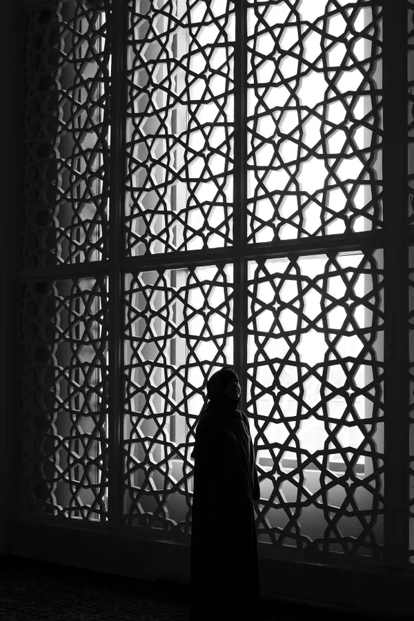 portrait of a girl near the window of a mosque thumbnail