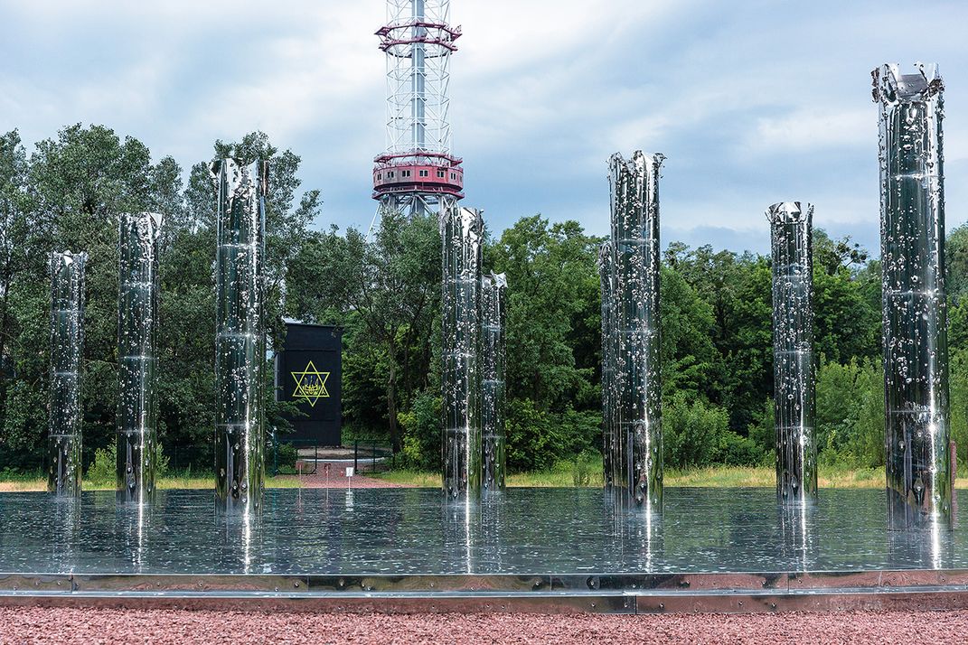 Mirror Field, whose ten reflective steel columns, torn apart by 100,000 bullet holes, represent the damaged “tree of life.”