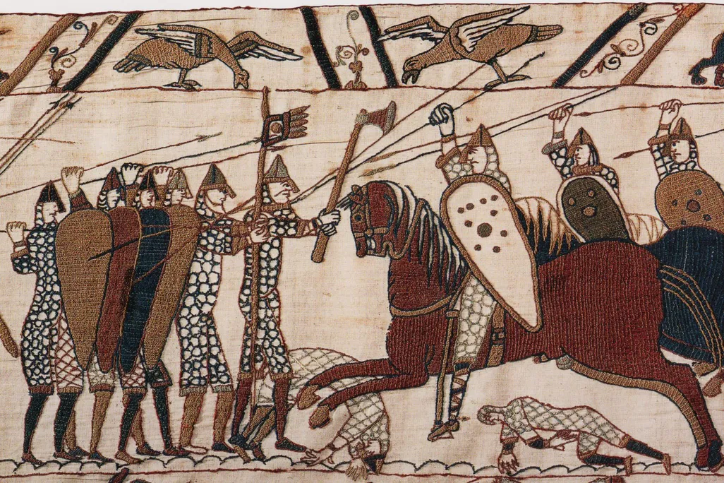 Part of scene 52 of the Bayeux Tapestry. This depicts mounted Normans attacking the Anglo-Saxon infantry.