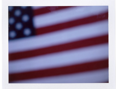 An American flag sits atop a gravestone in the cemetery of Oak Mountain Baptist Church in Shelby County, Alabama.