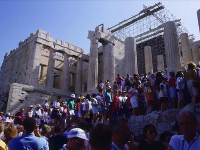 Crowds gather outside the front gate of the Acropolis.