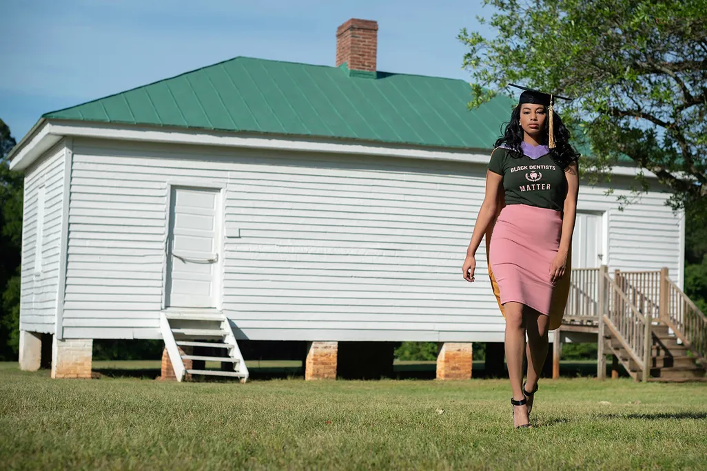 Breanna Henley poses in front of a slave cabin at Redcliffe Plantation in 2021