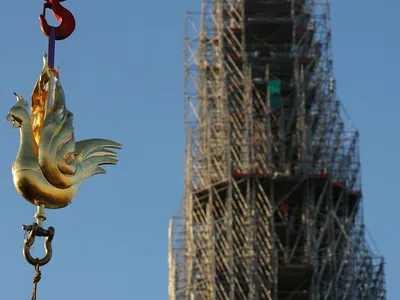 A crane lifts the new golden rooster to the top of Notre-Dame Cathedral&#39;s spire on December 16, 2023.