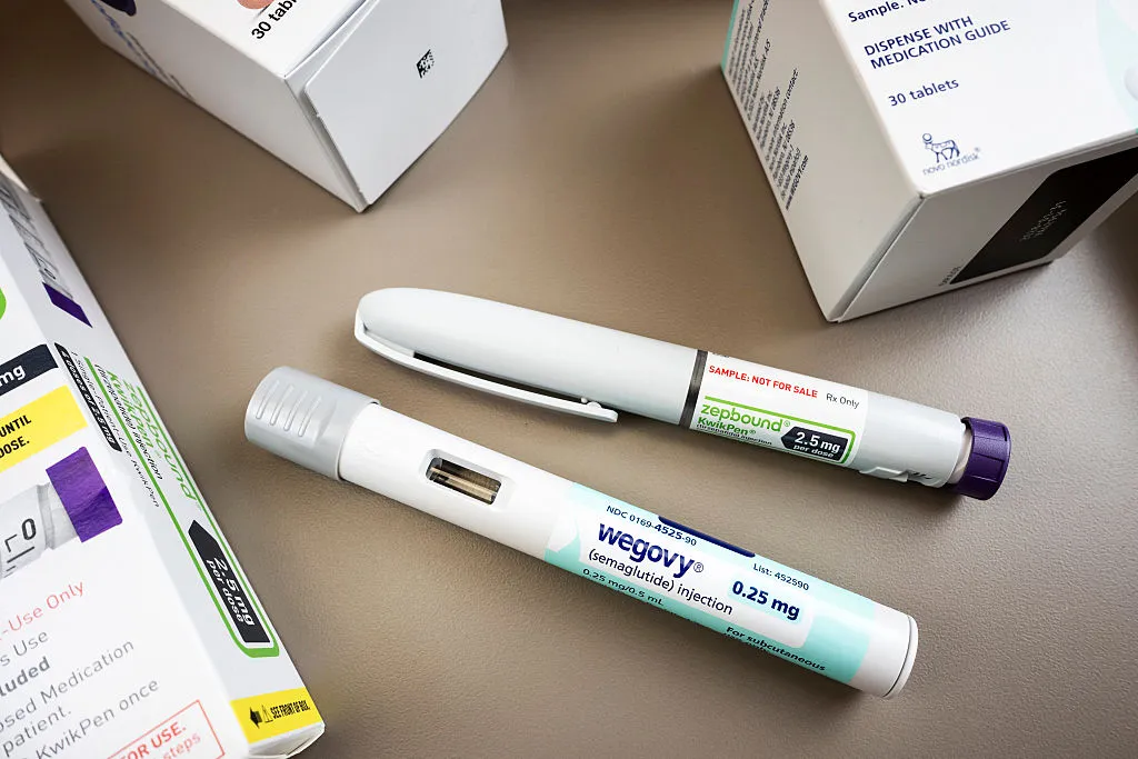 GLP-1 injection pens on a table, including wegovy and zepbound