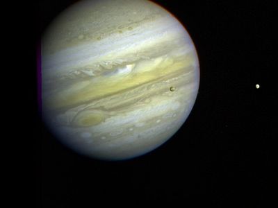 Three of Jupiter’s moons, Callisto, Io, and Europa can be seen orbiting the gas giant.