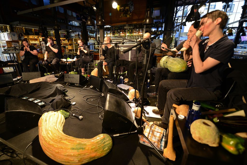 People playing instruments made from vegetables on a stage