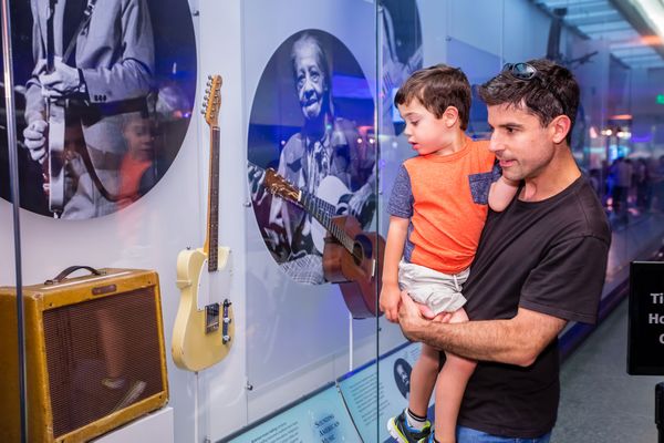 Man and child looking at guitar