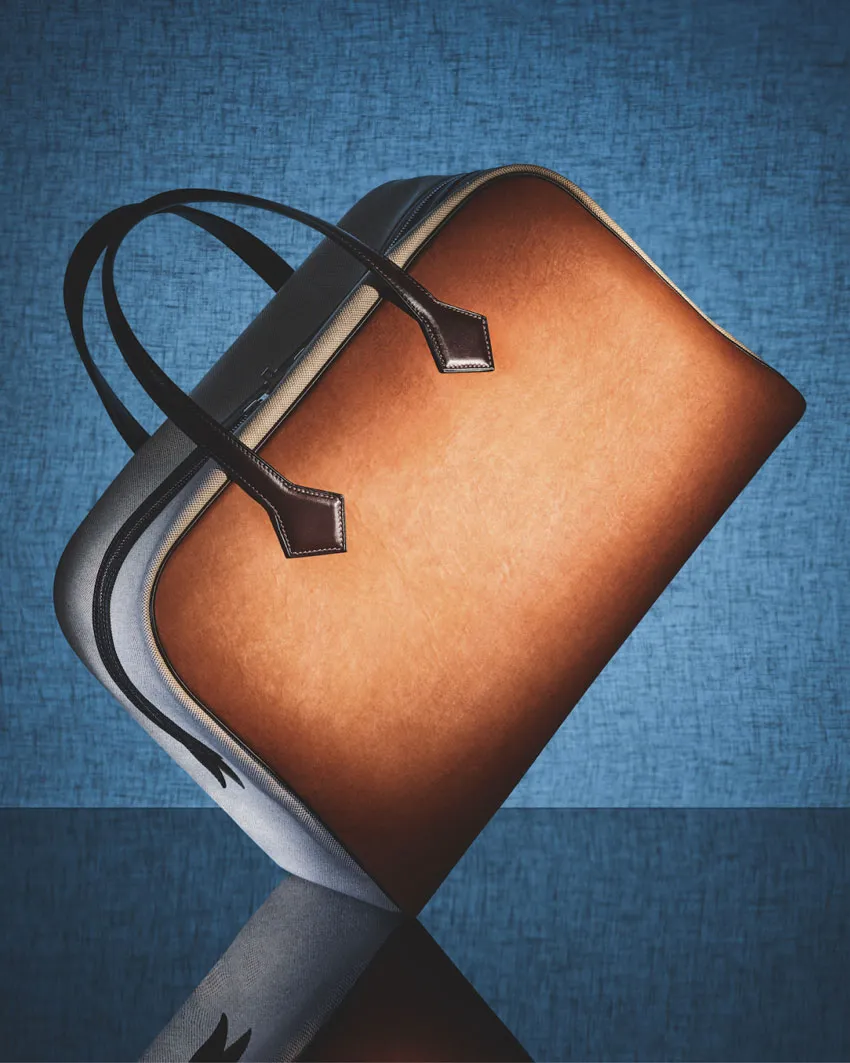 An image of a handbag in display against a blue background