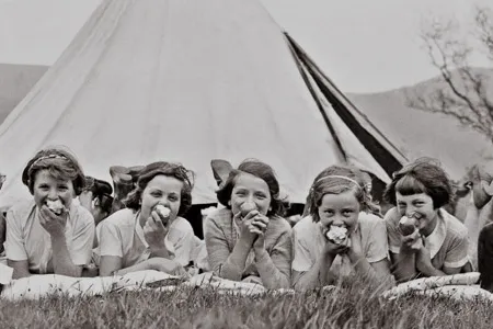 Girls eating apples on a field in Castleton, Derbyshire on May 26, 1937.