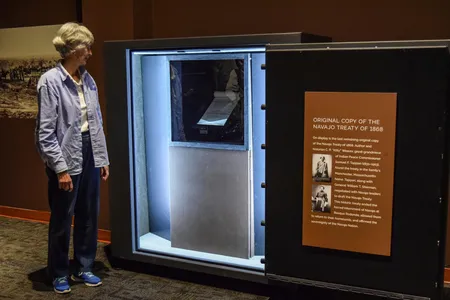 Clare "Kitty" Weaver poses next to the first public display of her ancestor's copy of the Navajo Treaty of 1868 prior to the 150th Commemoration of its signature at Bosque Redondo Memorial at Fort Sumner, N.M. in June 2018.