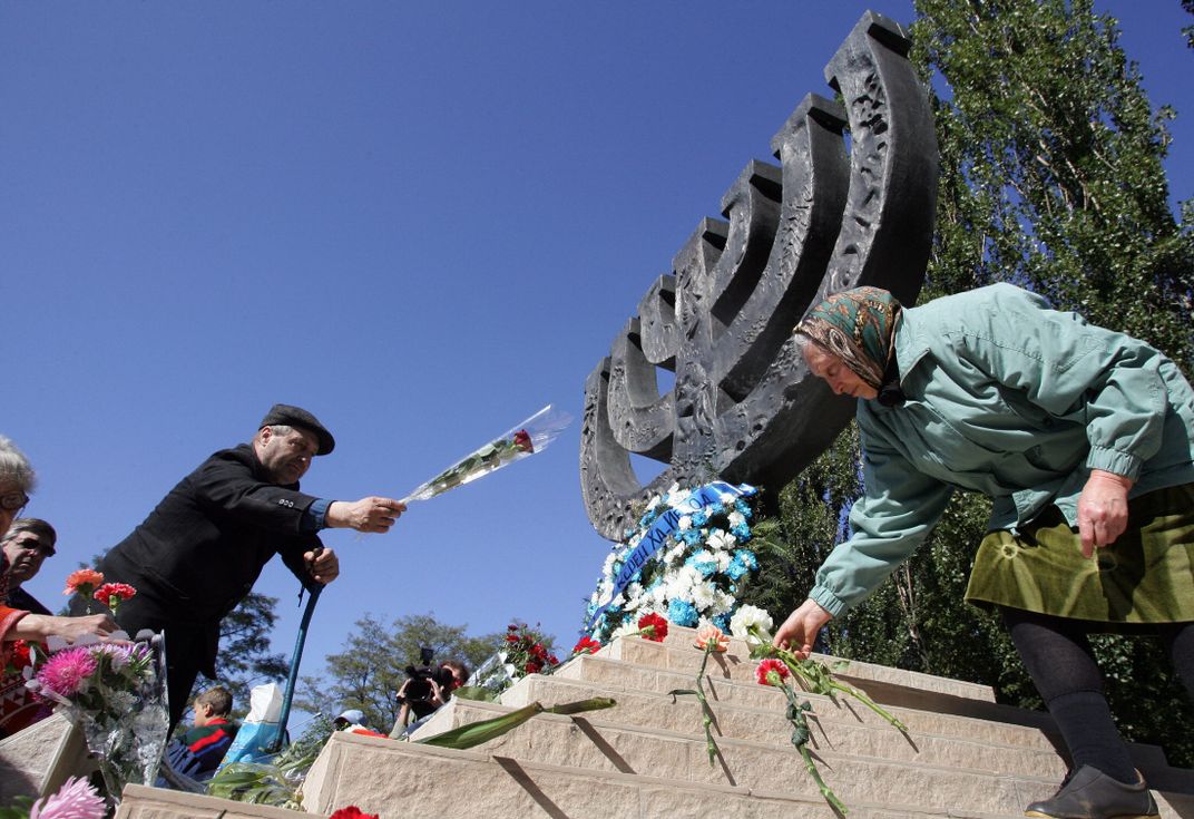 Ukrainian Jews lay flowers during a memorial ceremony at the Babi Yar menorah monument in September 2007.