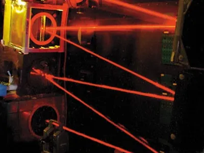 An engineer adjusts the beam-control optics that ride in the nose of the Airborne Laser Testbed, a modified Boeing 747-400F. The optics stabilize and shape the weapon laser’s beam as it is aimed by the nose turret’s computer-controlled telescope at a targ