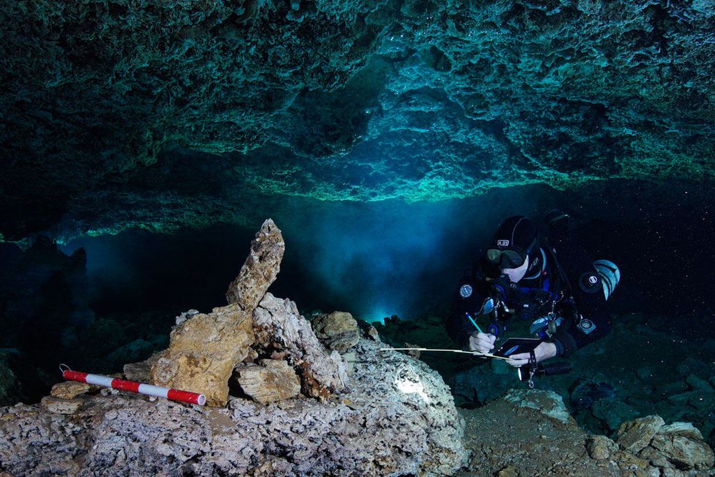 Diver examines rock pile