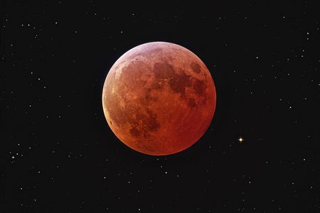 The Moon during an eclipse, with an orange cast. 