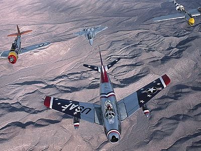 At the 2002 Nellis Air Show near Las Vegas, a Sabre heads up an A team in a USAF Heritage Flight: (from left) P-51 Mustang, P-47 Thunderbolt, F-15 Eagle, P-38 Lightning, and TF-51.