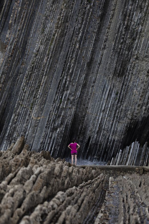 A woman visits the geological flysch formations of Zumaia beach thumbnail