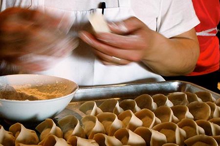 Chef Phillip Tang of East by Northeast rolls dumplings stuffed with Vermont pork and Massachusetts cabbage.