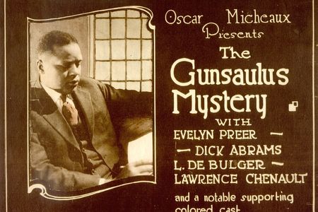 A lobby card for Gunsaulus Mystery, a 1921 silent film written, directed and produced by Oscar Micheaux, an early black silent film auteur. 