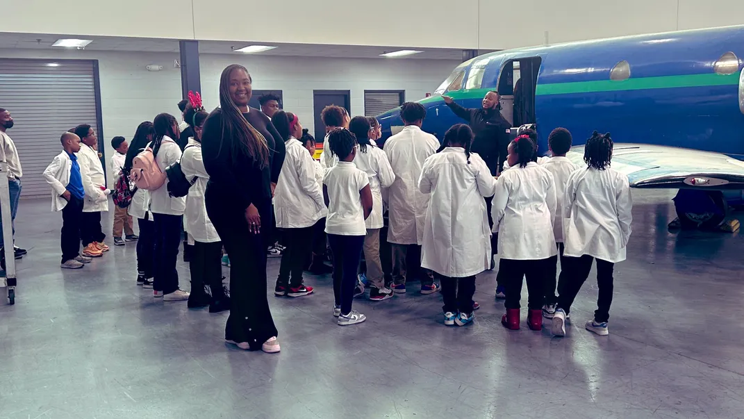 Students listen to an expert in aviation