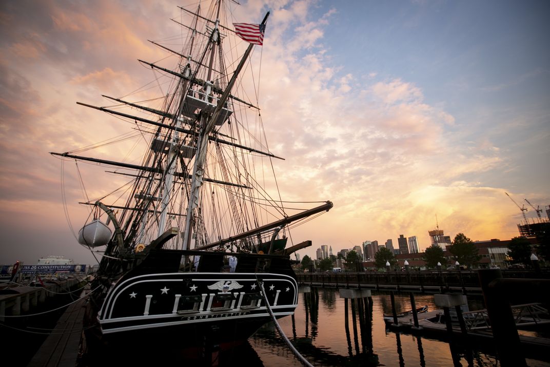 Large three-mast warship at Dock during sunset