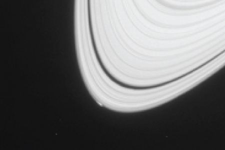 The bright spot on the lower left of Saturn's A ring is not Peggy, but rather the visible sign of Peggy's gravitation distortion of the ring structure.
