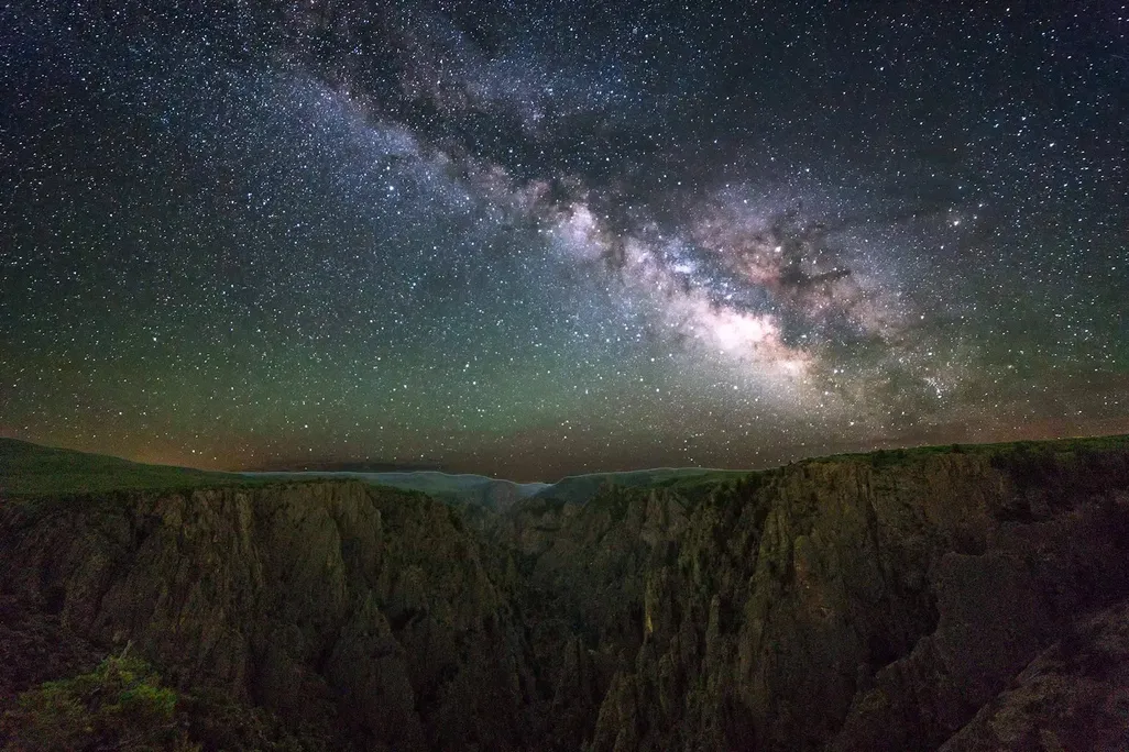 The Milky Way in view above a canyon landscape