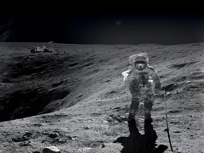 On their first Apollo 16 moonwalk, John Young and Charlie Duke (pictured) made their way to a crater named Plum. Their lunar rover waits in the background. Duke remembers the rover ride as bumpy, but stable.