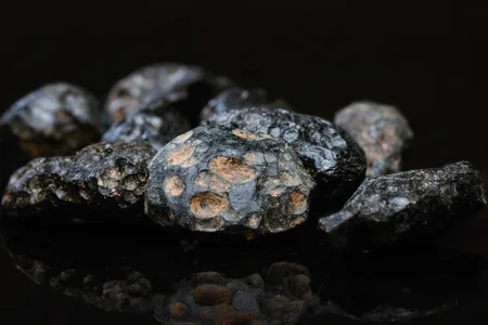 A large meteorite can launch bits of molten rock into the atmosphere when it impacts Earth. When that molten rock cools, it forms tektites, shown here.