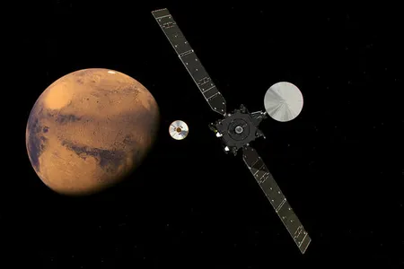 An illustration of the Schiaparelli lander detaching from the Trace Gas Orbiter as it makes its way to the surface of Mars