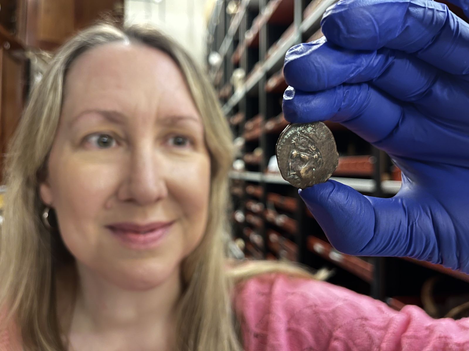 Kat Baxter, curator of archaeology and numismatics for Leeds Museums and Galleries, poses with the 2,000-year-old coin.