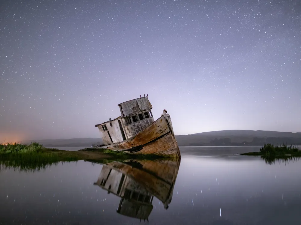 Beached ship against night's sky